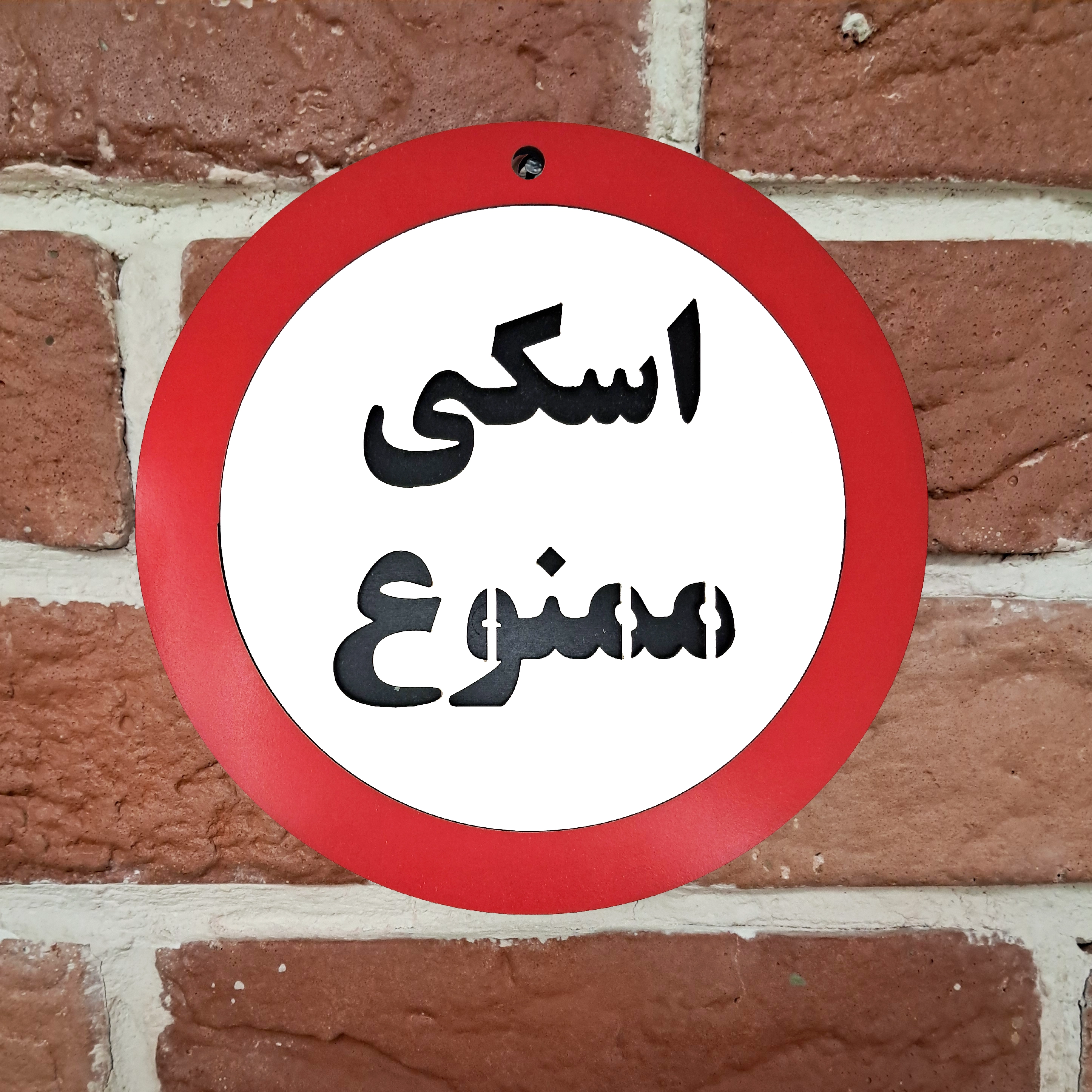 تابلو اخطاری علامت اسکی ممنوع نصب شده روی دیوار با میخ